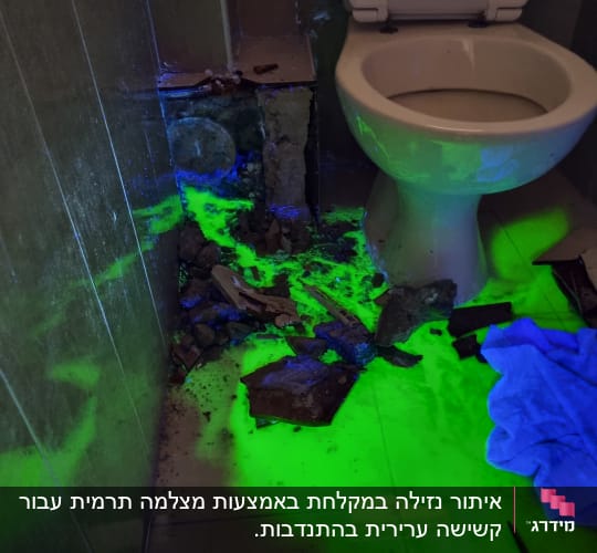 נזילה זוהרת ירוקה ליד אסלה בחדר אמבטיה